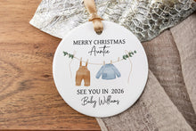 Load image into Gallery viewer, Merry Christmas Auntie ornament with text and baby illustrations on a wooden surface