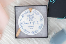 Load image into Gallery viewer, Blue Toile Christmas Ornament with 'Names Married 2025' text in a box on a textured surface.