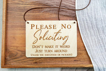 Load image into Gallery viewer, Rectangular birch wood No Soliciting sign with brown cord hanger, engraved with a funny message about turning around unless delivering food or packages.