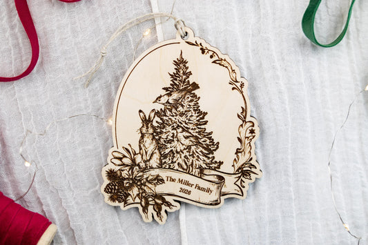 Personalized wooden family Christmas ornament with detailed vintage tree illustration, decorative floral border, and hanging cord.