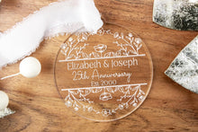 Load image into Gallery viewer, Clear Acrylic Personalized 25th anniversary ornament with engraved Names and wedding year on a wooden surface with decorative elements.

