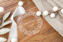 Load image into Gallery viewer, Clear acrylic round engagement ornament on engraved with names and engagement date with thick floral wreath. Displayed on a wooden tray. 
