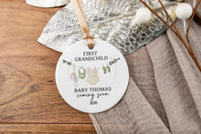 Load image into Gallery viewer, Personalized ceramic ornament for first girl grandchild. Personalized with the baby's last name and due year on a wooden tray with decorative elements.
