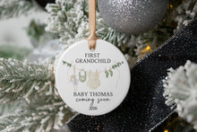 Load image into Gallery viewer, Personalized ceramic ornament for first girl grandchild. Personalized with the baby's last name and due year on a wooden tray with decorative elements.
