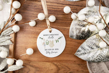 Load image into Gallery viewer, Round Merry Christmas Auntie ornament with personalization of last name and due year on a wooden surface with decorative elements.
