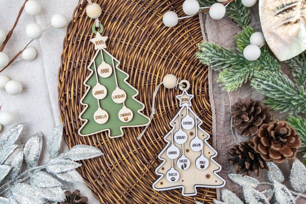 Decorative Christmas family tree ornaments with text on a textured surface with winter elements.