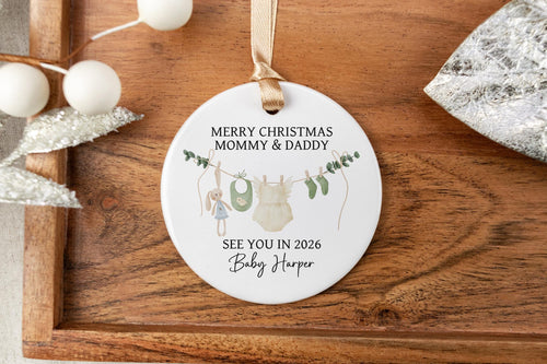 Personalized Merry Christmas Mommy & Daddy ornament on a wooden tray with decorative elements.