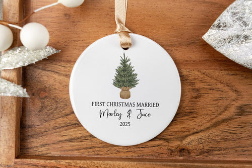 Personalized First Christmas Married ornament with a tree design on a wooden tray.