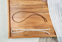Load image into Gallery viewer, Brown suede cord and white cotton rope hanger options displayed on a wooden tray.
