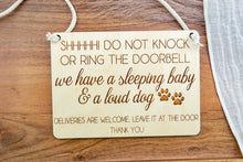 Load image into Gallery viewer, Rectangular wooden do not knock or ring doorbell sign with engraved lettering and white rope hanger.

